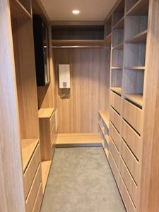 Walk-In-Wardrobe-Polytec-Natural-Oak-Colour-Board-Shelving-Banks-of-Drawers-Chrome-Hanging-Rod